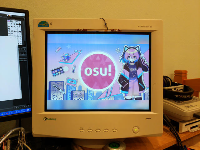 An osu! background with an anime girl on pastel vaporwave colors, being displayed on my VGA monitor.
